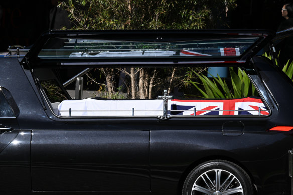 The casket of paramedic Steven Tougher arrives in a hearse to his memorial at the University of Wollongong on Monday.