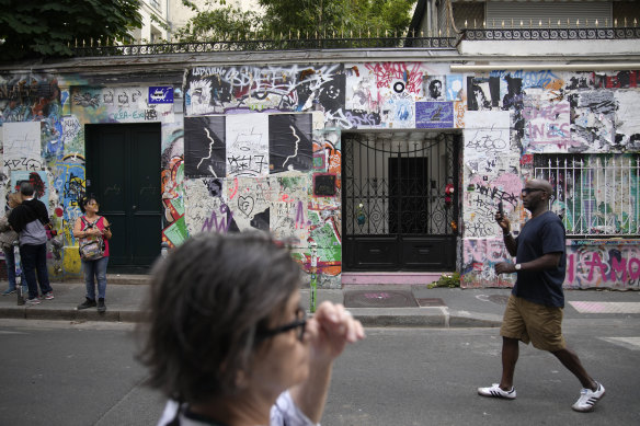 People walk by at the house where Jane Birkin and Serge Gainsbourg lived in Paris. 