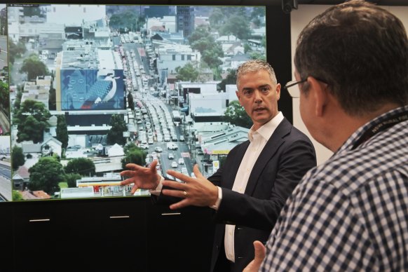 Roads Minister John Graham in the transport management centre early on Thursday morning. A screen in the background shows Victoria Road in Drummoyne.
