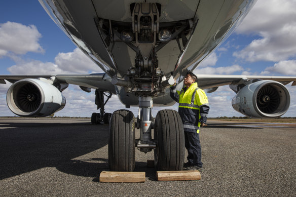 An engineer works on the Airbus A330 to prepare it for resumption of flying. 