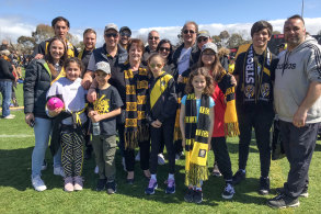Jenny Kefalas, centre front with scarf, brought a large group of relatives to the Richmond Football Club family day at Punt Road Oval. 