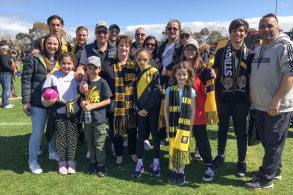 Jenny Kefalas, centre front with scarf, brought a large group of relatives to the Richmond Football Club family day at Punt Road Oval. 