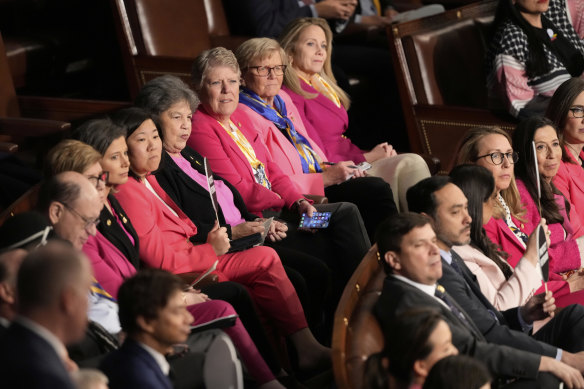 Democratic members of Congress listen as President Donald Trump addresses a joint session of Congress.