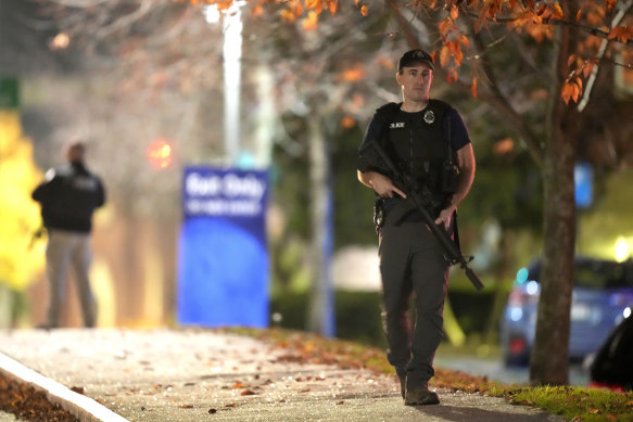 Law enforcement officers carry rifles outside Central Maine Medical Centre.