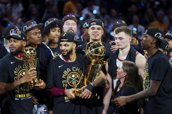 Denver Nuggets guard Jamal Murray holds the Larry O’Brien NBA Championship Trophy.