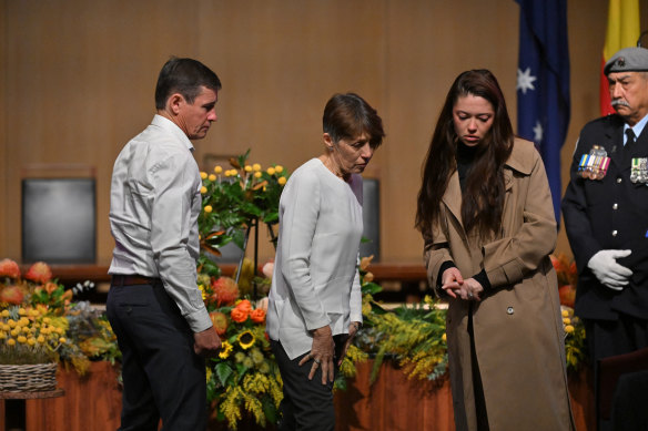 Families of the victims place flowers on a wreath during a ceremony marking 10 years since the downing of Malaysia Airlines Flight 17 (MH17), in the Great Hall at Parliament House in Canberra. 