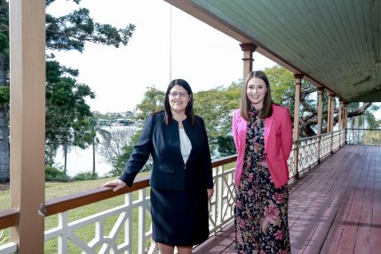 Heritage Minister Meaghan Scanlan (right) with local MP and Education Minister Grace Grace on the veranda of Newstead House as it begins a $5 million restoration.