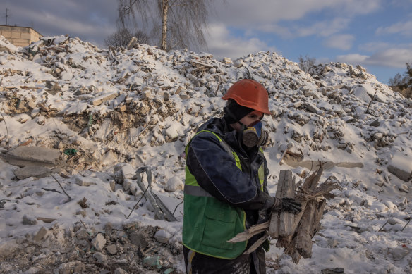 A demolition employee works on a site of a demolished residential building that was heavily damaged during Russian attacks, in Hostomel, Ukraine. 