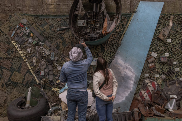 Visitors in Kyiv look at parts of Su-34, a Russian fighter-bomber, that was shot down by the air defence of Ukraine.