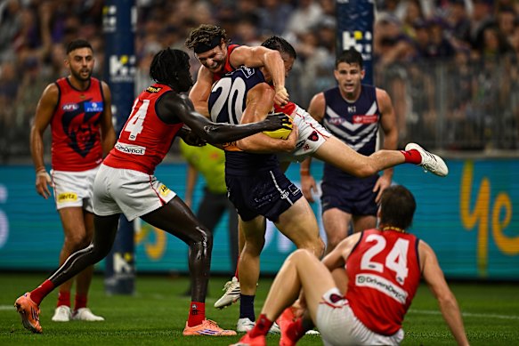 Dockers strongman Patrick Voss lifts Ed Langdon up.
