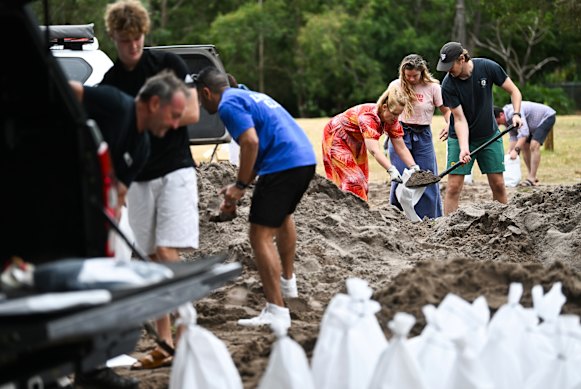 Residents fill up sandbags at the Toowong Bowls Club in Brisbane on Friday.