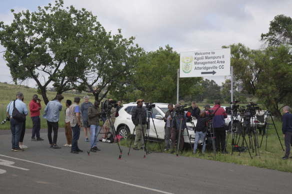 Television crews, photographers and reporters gather outside the gates of the Atteridgeville Correctional Centre in the South African capital of Pretoria, South Africa, waiting to catch a glimpse of the world-famous double-amputee Olympic runner, Oscar Pistorius, to be released on Friday.