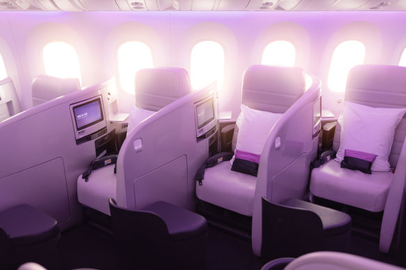 Air New Zealand’s current business class seats on board their Dreamliners: three lengthwise rows of seats with chest-high partitions are angled diagonally into the cabin.