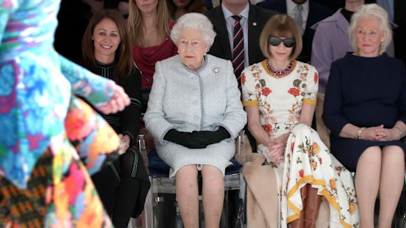 Queen Elizabeth sitting between Vogue editor Anna Wintour and her dressmaker Angela Kelly at a London Fashion Week show.
