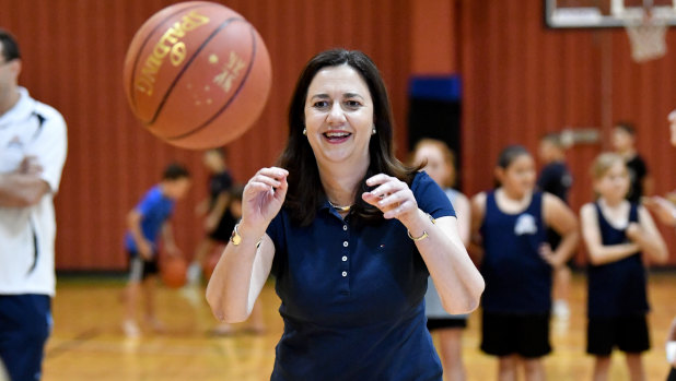 Premier Annastacia Palaszczuk is seen playing basketball with members of the Wizards Basketball club at the Brisbane Entertainment Centre in Brisbane on Saturday.