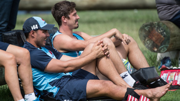 Relaxing: Injured NSW halfbacks Nick Phipps and Jake Gordon looking on at training. 