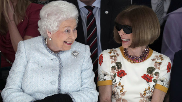 Queen Elizabeth sits next to fashion editor Anna Wintour during a show at London Fashion Week.