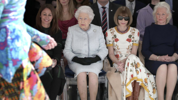 Queen Elizabeth sitting between Vogue editor Anna Wintour and her dressmaker Angela Kelly at a London Fashion Week show.