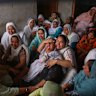 Jabir Kaur, wife of Sukhwinder Singh, center, wails after her husband died consuming toxic liquor, in Majitha village on the outskirts of Amritsar, India.