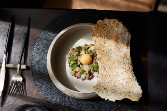 Veal tartare with cornichon, caper, shallot and herbs, egg yolk truffle cream and house-made lavosh.