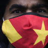 A protester wears a face mask in the colors of the Tigray regional flag as he attends a protest in Berlin, Germany in January.