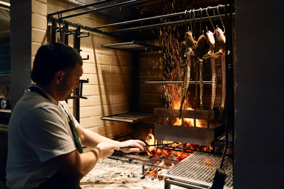 Cooking over the custom wood-fired hearth at Poetica. 