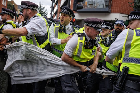 Police Officers move in to arrest people associated with the ‘anti-fascist’ movement outside the Barbican Thistle Hotel as anti-immigration, ‘stand up to racism’ and ‘anti-fascist’ groups all gather outside in London, England.