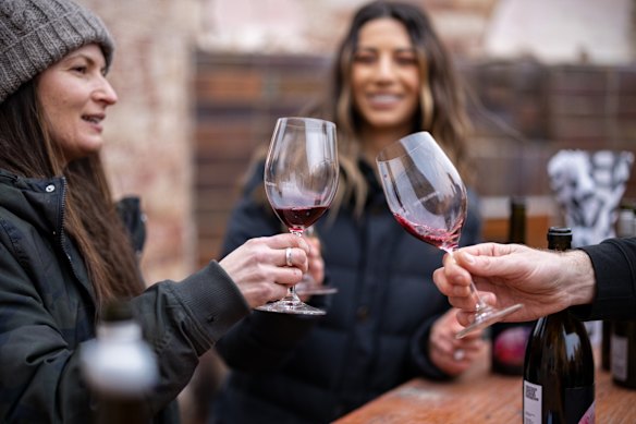 Friends enjoy a wine at the Winter Reds Festival held in Adelaide recently.