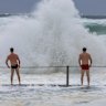 Weather. Mikey and Patch May check out the wild surf conditions from the Cronulla rock pool.