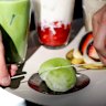 Splitting a matcha flavoured daifuku with a piece of string at Sydney Daifuku Store.