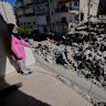A woman looks through her damaged apartment that was hit a few weeks ago by an Israeli air strike in the southern city of Tyre.
