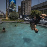 “Feels like” temperature recently reached 70 degrees in Iran. A young boy jumps into a pool to cool down at a square in downtown Tehran.