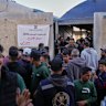 Palestinian men gather in front of a polling station to participate in local elections in Deir al-Balah, central Gaza Strip, on Saturday.