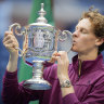 Jannik Sinner kisses the US Open trophy after defeating Taylor Fritz.