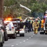 Emergency services personnel at the scene of the fatal crash near Hanging Rock on Thursday.