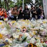 Huge crowds lay flowers to pay tribute to the victims of the Tai Po fire.