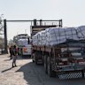 RAFAH, EGYPT - JULY 27: Trucks carrying aid enter Gaza through the Rafah border crossing on July 27, 2025 in Rafah, Egypt. Israel announce a “tactical pause” in fighting in some parts of Gaza, including near the Rafah crossing, from 10 AM to 8 PM today to allow for shipments of humanitarian aid, as concern grows about a deepening hunger crisis in the Palestinian territory. (Photo by Ali Moustafa/Getty Images)