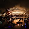 Golden fireworks spray from the Sydney Harbour Bridge.