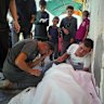 Relatives mourn after 10 people, including several children, were killed in an Israeli strike while they were waiting to receive nutritional supplements at a Project Hope-run medical clinic in Deir al-Balah on Thursday.
