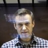 Russian opposition leader Alexei Navalny looks through a glass cage during a court appearance in 2021.
