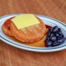 Pancakes with butter, blueberry compote and maple syrup.
