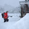 A postwoman delivers the mail in Lumsden, Scotland, on Tuesday.