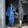 A police officer in the burnt shopfront on Wednesday morning.