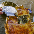 Three-cheese lasagne with overhanging edges for extra crispy bits.