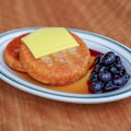 Pancakes with butter, blueberry compote and maple syrup.