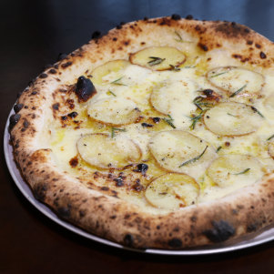 Potato pizza with potato, gorgonzola cream, fior di latte, rosemary and parmigiano.