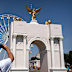 Visitors take photos of a model of President Donald Trump’s proposed Triumphal Arch.
