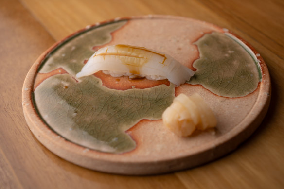 Cuttlefish nigiri with sea urchin soy sauce. 