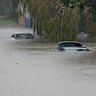BRISBANE, AUSTRALIA - MARCH 09: Flooded cars at Edmondstone Street in the suburb of Newmarket on March 09, 2025 in Brisbane, Australia. Australia’s east coast is experiencing severe weather as ex-Tropical Cyclone Alfred moves south. While downgraded from cyclone status, the weather system continues to bring damaging winds, heavy rainfall, and flash flooding, particularly in the Gold Coast and northern NSW regions. Authorities have issued severe weather warnings, and coastal areas remain at risk of significant erosion and hazardous surf conditions. Residents are urged to stay updated on local warnings, avoid floodwaters, and prepare for ongoing disruptions. (Photo by Albert Perez/Getty Images)