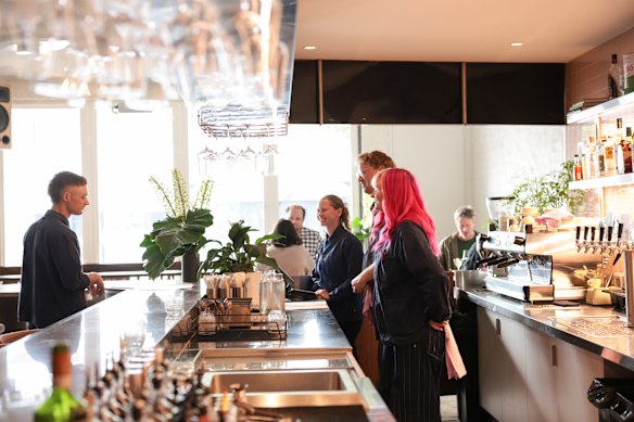 Daphne’s bar (pictured) and open kitchen run along one wall of the space, with counter seating.